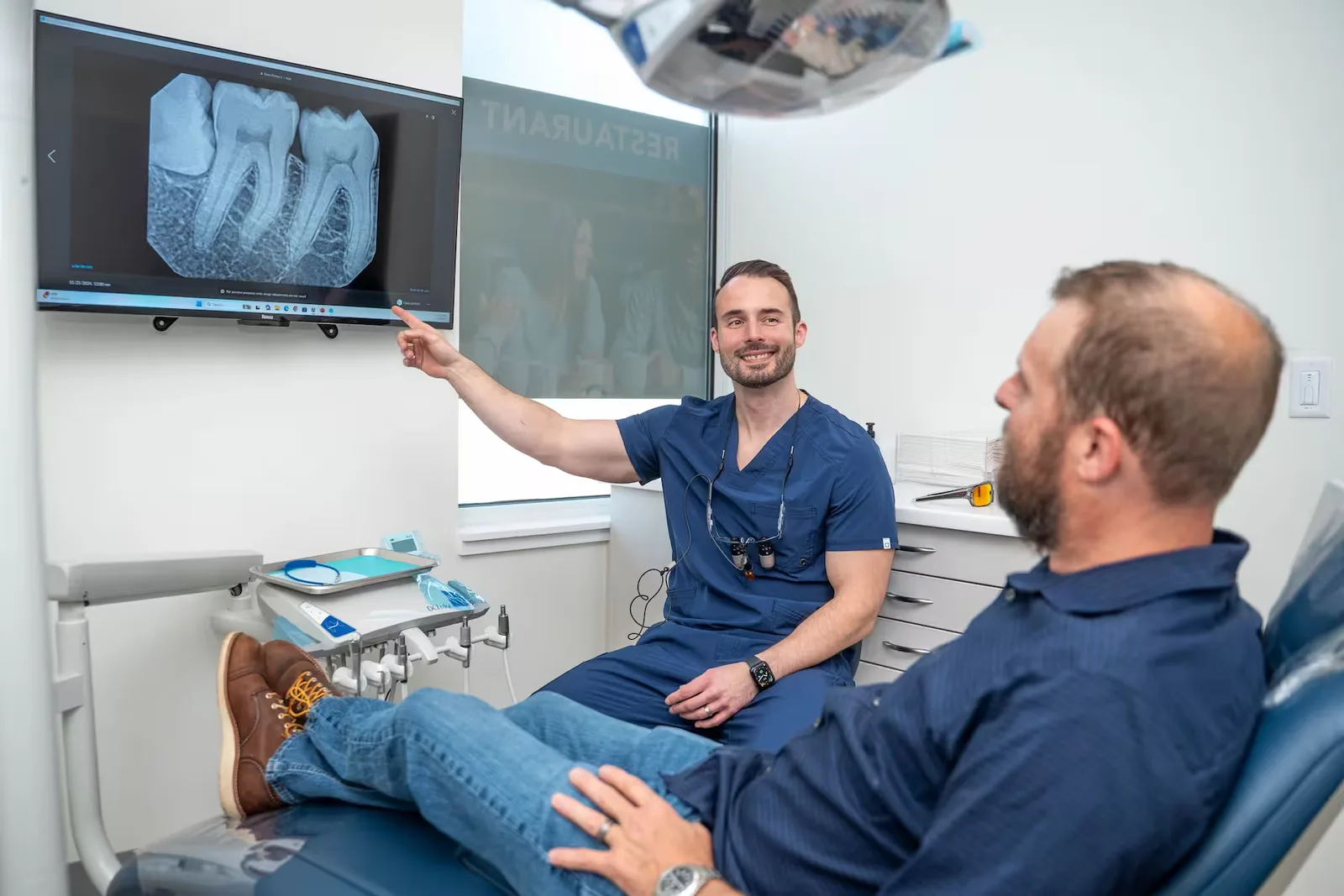 Dr. Jonathan Adler consulting with a patient over a digital X-ray