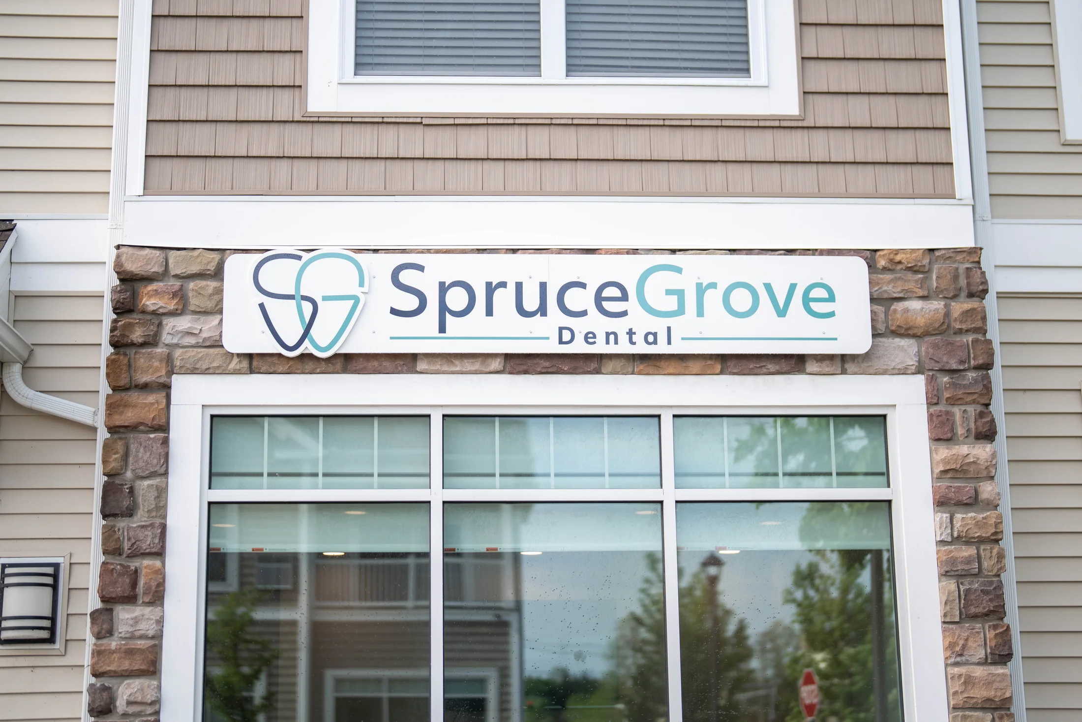 Spruce Grove Dental exterior sign above the office windows