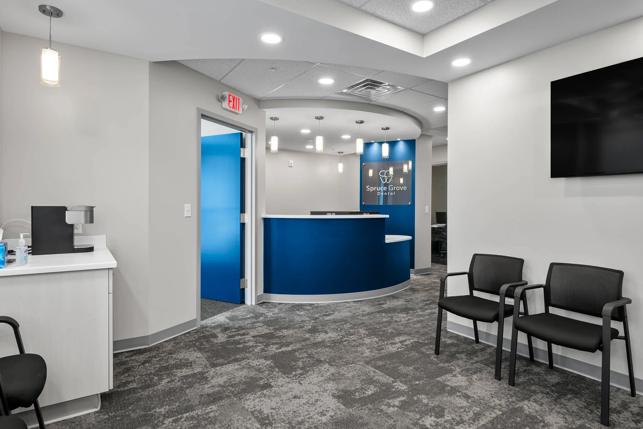 Reception area with seating and the Spruce Grove Dental front desk