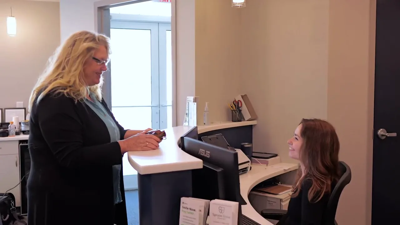 Spruce Grove Dental front desk team welcoming a patient